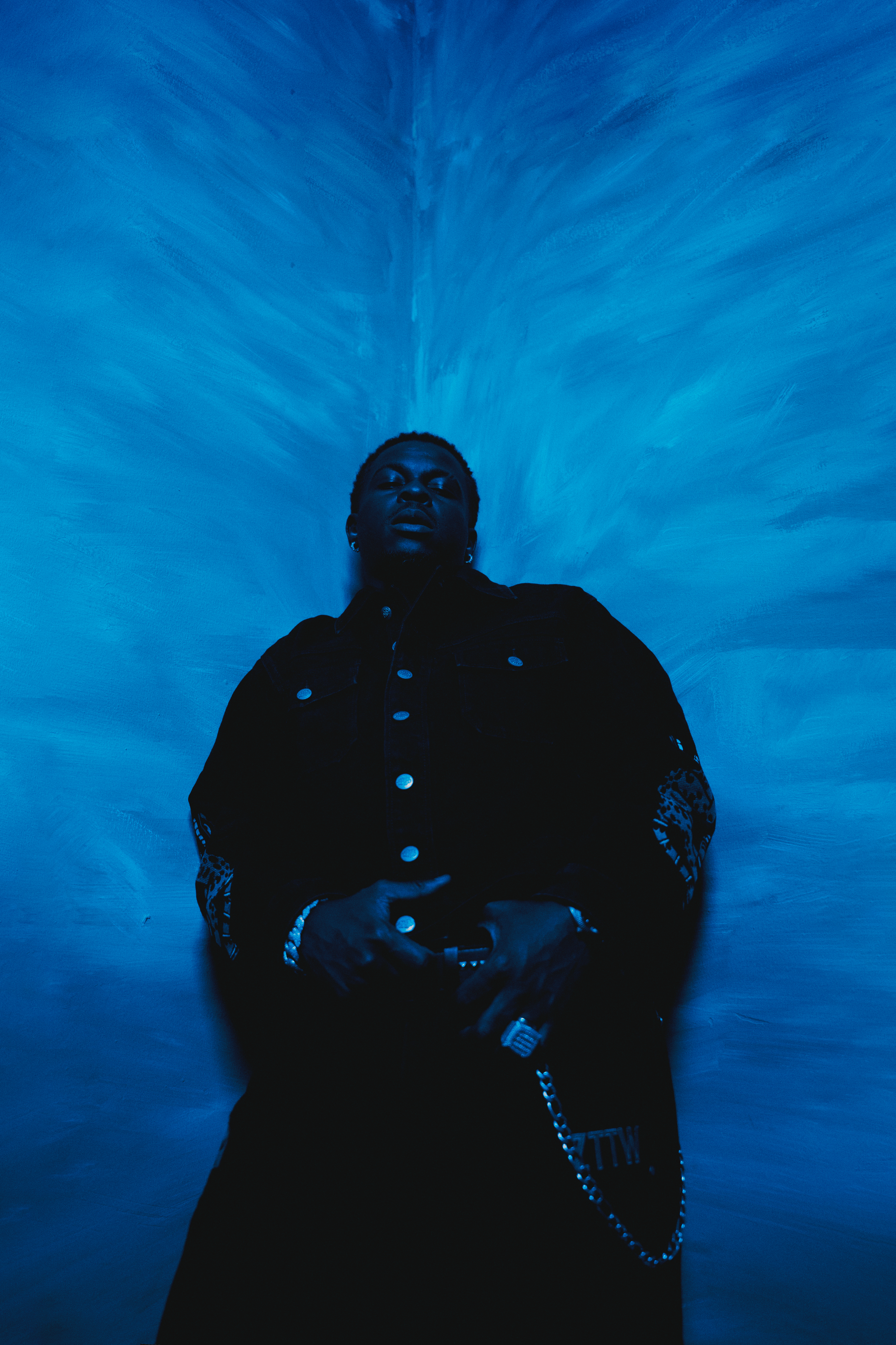 Artist portrait — deep blue radiating backdrop
